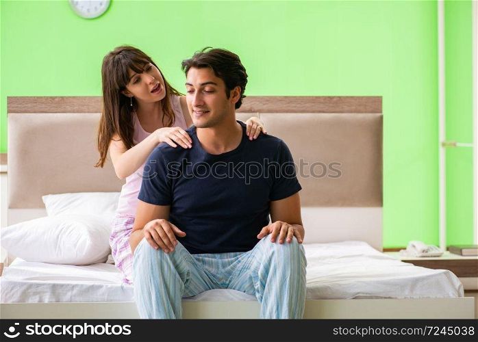 Woman doing massage to her husband in bedroom . The woman doing massage to her husband in bedroom 