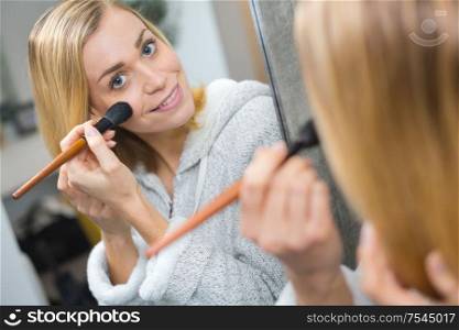 woman doing morning makeup routine