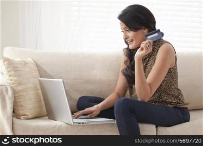 Woman doing net banking on laptop