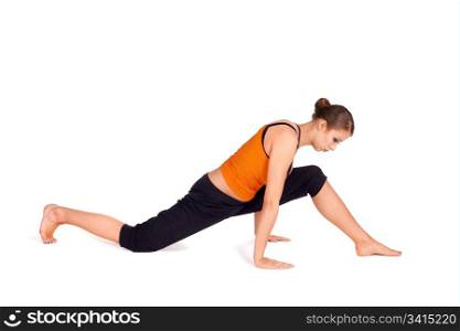 Woman doing preparation exercise for Monkey God Pose yoga posture, sanskrit name: hanumanasana, this pose stretches the thighs, hamstrings, groins, hip flexors and lower back muscles, stimulates the abdominal organs