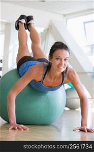 Woman Doing Push Ups On Swiss Ball At Gym