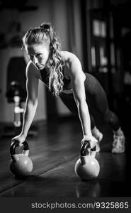 Woman Doing Push-ups with kettlebells