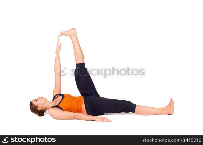 Woman doing Reclining Big Toe yoga pose (there are four versions of this exercise), sanskrit name: Supta Padangusthasana, this pose stretches the hips, groins, thighs, hamstrings, calves, relieves backache, sciatica, and menstrual discomfort