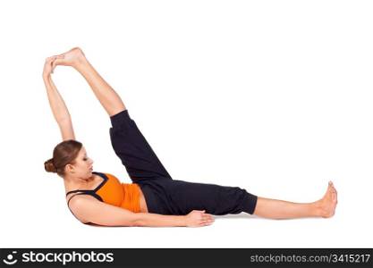 Woman doing Reclining Big Toe yoga pose (there are four versions of this exercise), sanskrit name: Supta Padangusthasana, this pose stretches the hips, groins, thighs, hamstrings, calves, relieves backache, sciatica, and menstrual discomfort.
