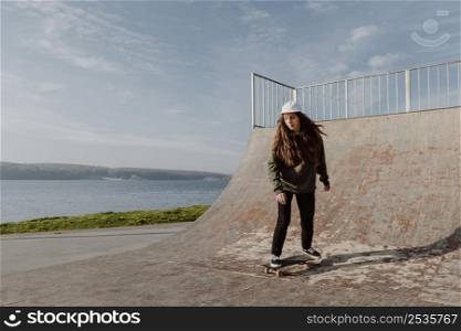 woman doing skateboard tricks lake 2