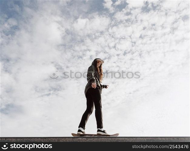 woman doing skateboard tricks low view