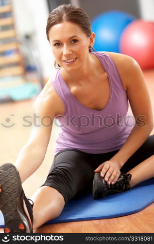 Woman Doing Stretching Exercises In Gym