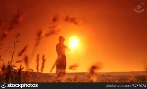 Woman doing stretching outdoors at sunset