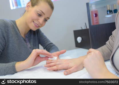 woman doing the manicure to customer