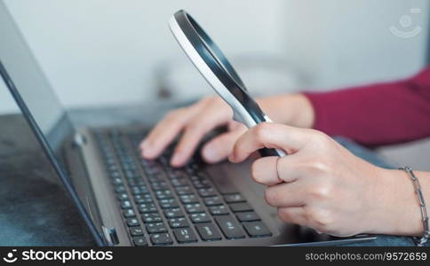 woman doing work and using a magnifying glass to look at data Suitable for making infographics.