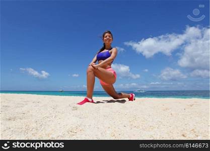 Woman doing workout on beach. Beautiful young woman doing workout on tropical beach