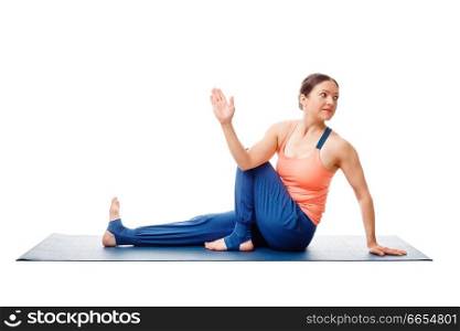Woman doing yoga asana Ardha matsyendrasana - half spinal twist pose posture isolated on white background. Woman doing yoga asana Ardha matsyendrasana isolated on white
