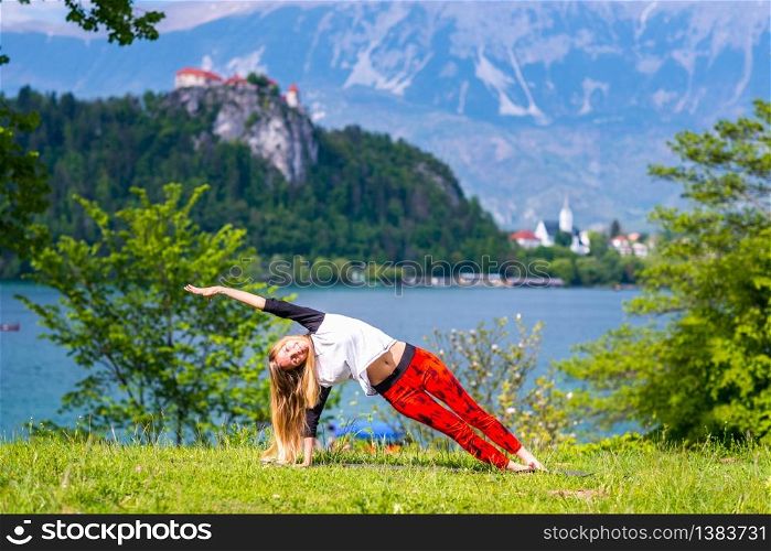 Woman doing yoga by the lake