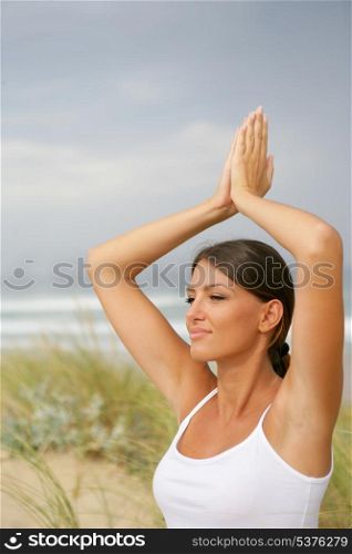 Woman doing yoga in the dunes