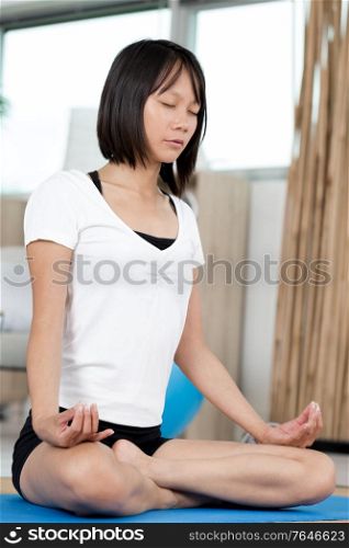 woman doing yoga in the morning at her home