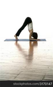 Woman Doing Yoga On A Hardwood Floor