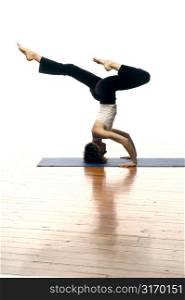 Woman Doing Yoga On A Hardwood Floor
