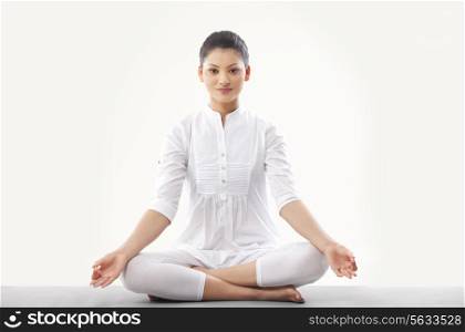 Woman doing yoga over white background