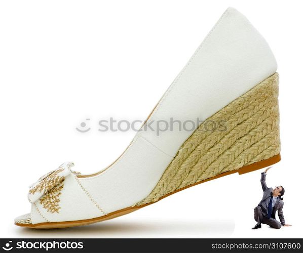 Woman domination concept with shoes and man