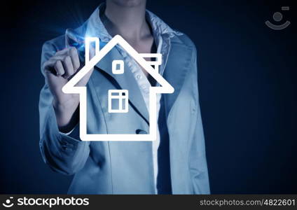 Woman draw house. Businesswoman drawing house with pencil on screen