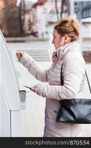 Woman drawing out money from ATM