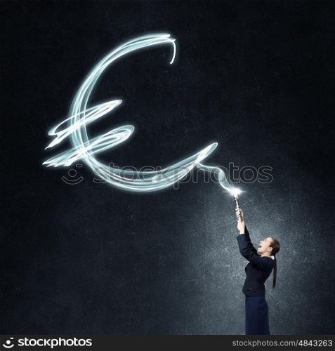 Woman drawing with lantern light. Businesswoman in darkness drawing euro sign with flashlight