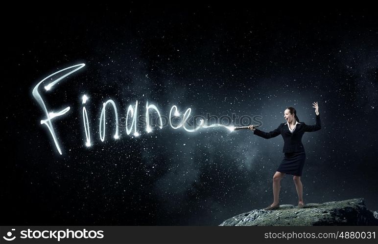 Woman drawing with lantern light. Businesswoman in darkness drawing success word with flashlight
