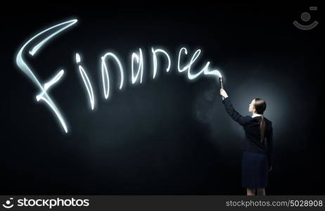 Woman drawing with lantern light. Businesswoman in darkness drawing success word with flashlight