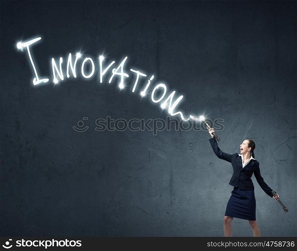 Woman drawing with lantern light. Businesswoman in darkness drawing word promotion with flashlight