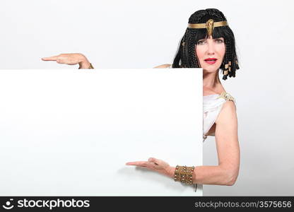 Woman dressed as Egyptian holding message board