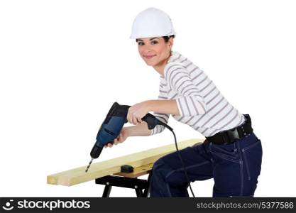Woman drilling wood