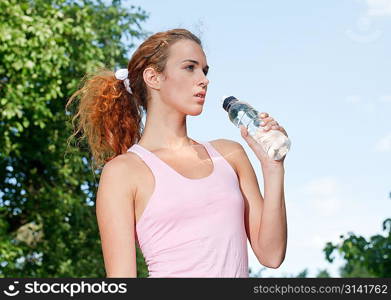 Woman drink water after jogging