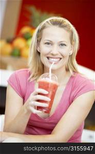 Woman Drinking A Berry Smoothie