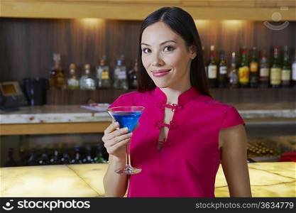 Woman Drinking a Blue Martini