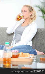 Woman drinking apple juice with breakfast