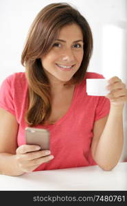 woman drinking coffee and checking her phone