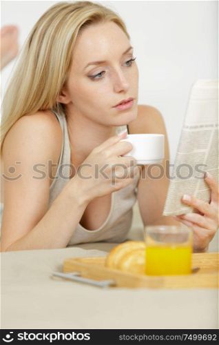 woman drinking coffee in bed