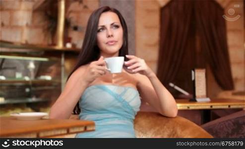 woman drinking coffee in cafeteria