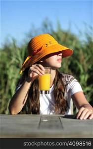 Woman drinking her juice during the summer holidays.