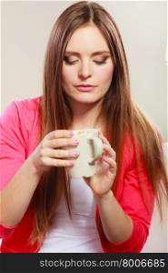 Woman drinking hot coffee beverage. Caffeine.. Woman drinking cup of coffee. Young girl with hot energizing beverage that keeps her awake. Energy and caffeine.