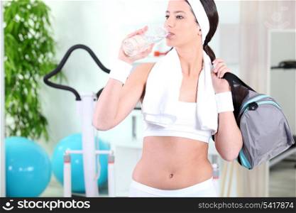 Woman drinking in the gym