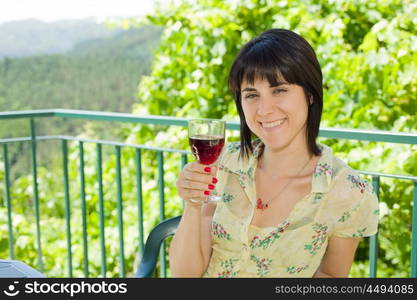 woman drinking red wine in a vineyard, outdoor