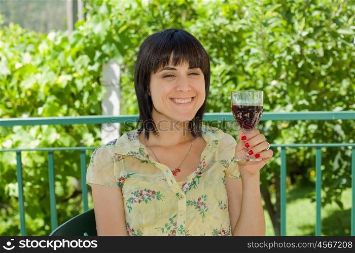 woman drinking red wine in a vineyard, outdoor