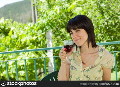 woman drinking red wine in a vineyard, outdoor