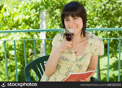 woman drinking red wine in a vineyard, outdoor