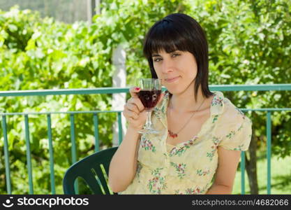 woman drinking red wine in a vineyard, outdoor