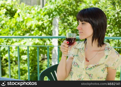 woman drinking red wine in a vineyard, outdoor