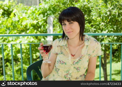 woman drinking red wine in a vineyard, outdoor