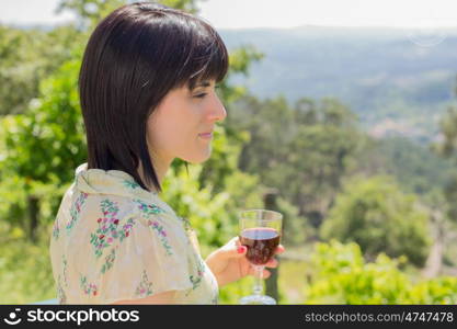 woman drinking red wine in a vineyard, outdoor