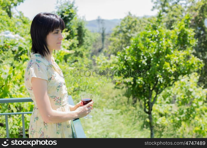 woman drinking red wine in a vineyard, outdoor